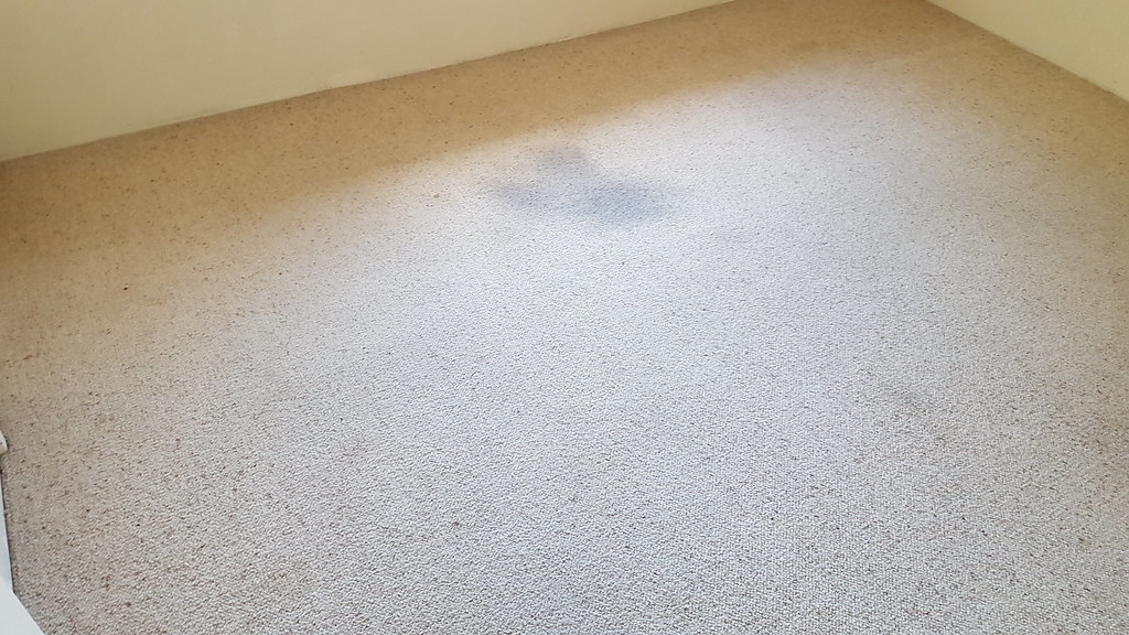 Heavy staining on bedroom carpet before professional deep cleaning
